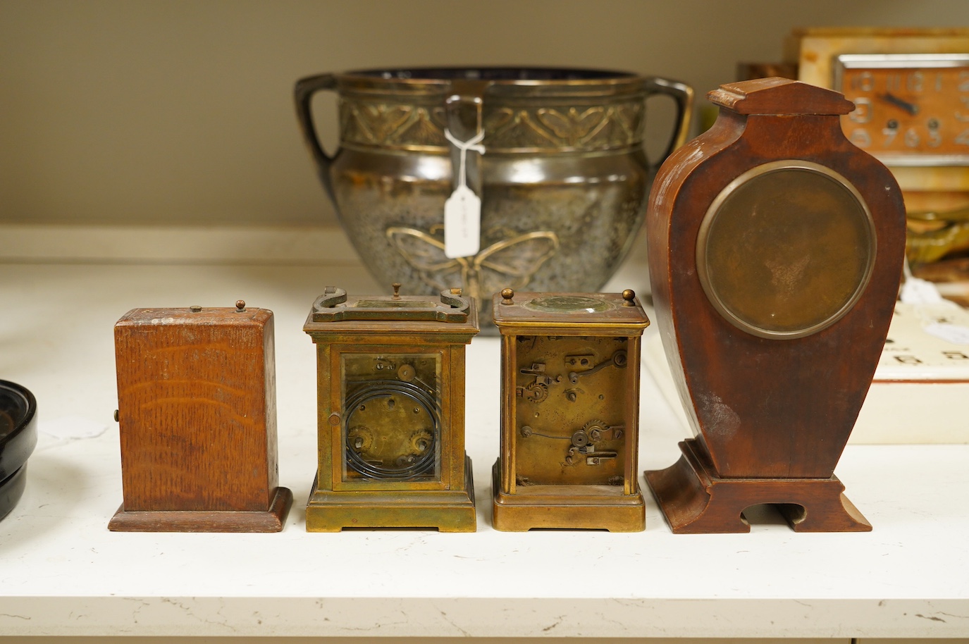 Two carriage clock, an Edwardian mantel clock, 25cm high, and a watch mounted in an oak case (4). Condition - fair, not tested for working